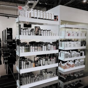 Shelves display various hair care and beauty products in a modern, brightly lit store interior.